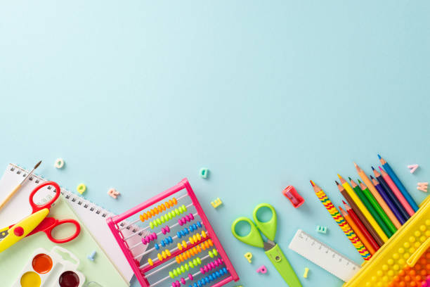 istock Immerse yourself into realm of education for young learners through this top view image: vibrant assortment of school supplies on isolated pastel blue background, ready for text or promotional content 1551517241