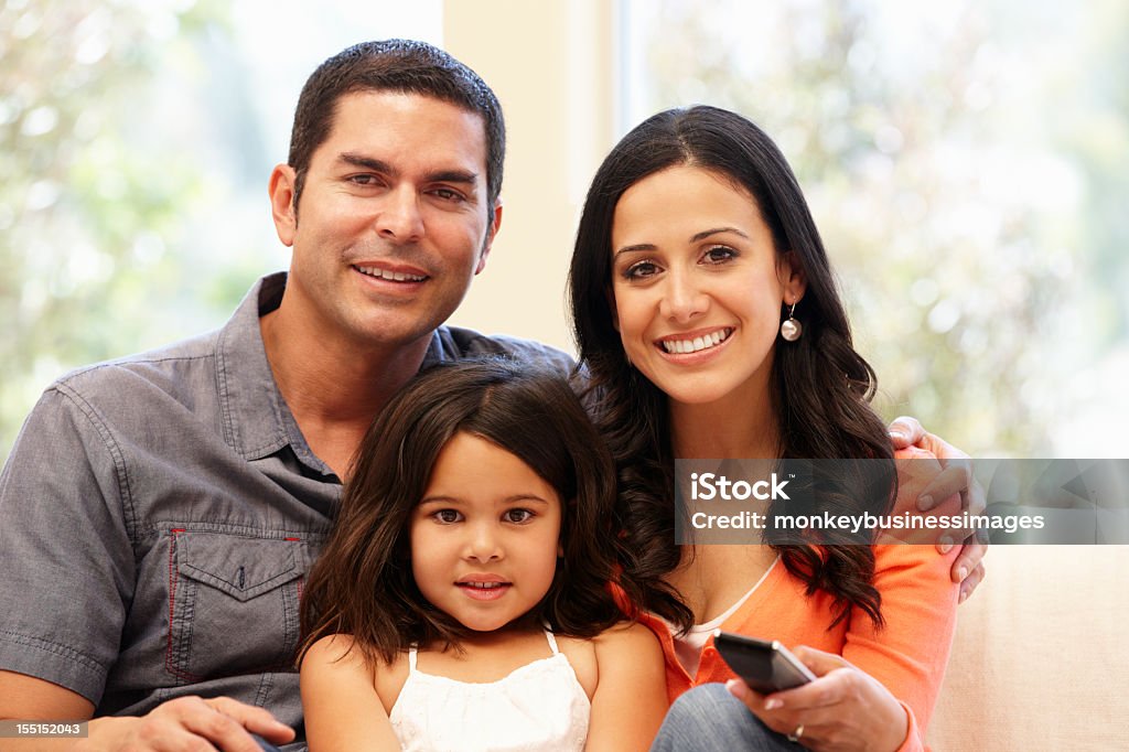 Hispanic family watching television Hispanic family watching television togther Family Stock Photo