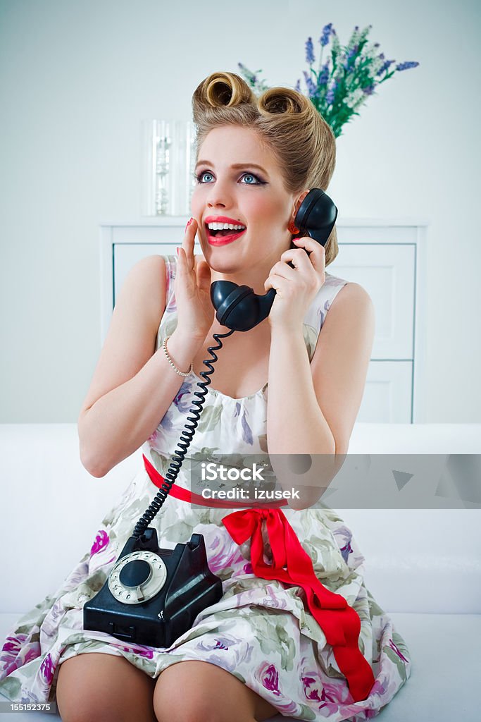 Happy retro woman on the phone Portrait of excited retro style young woman talking on vintage phone. 25-29 Years Stock Photo