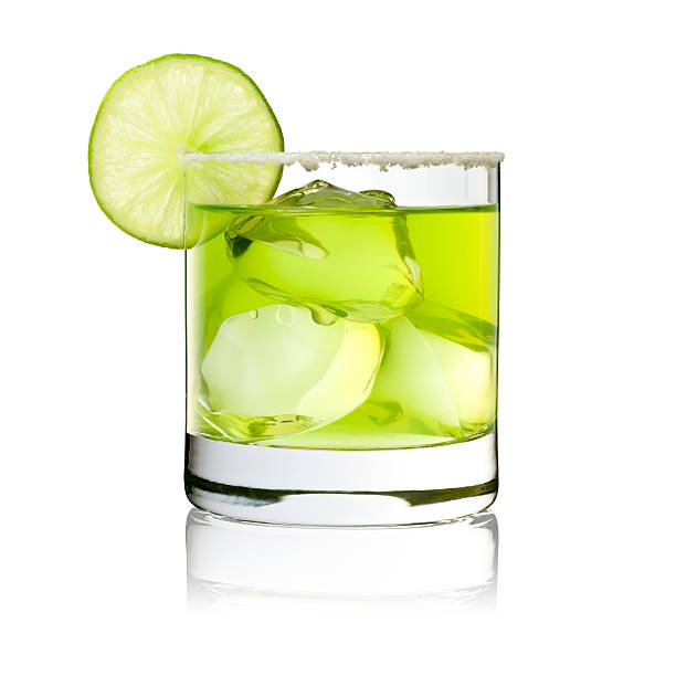 Margarita On The Rocks - Cocktail Glass Lime Green Photography of a classic Margarita with ice nuggets, salt-rand and lime decoration. ice cube photos stock pictures, royalty-free photos & images