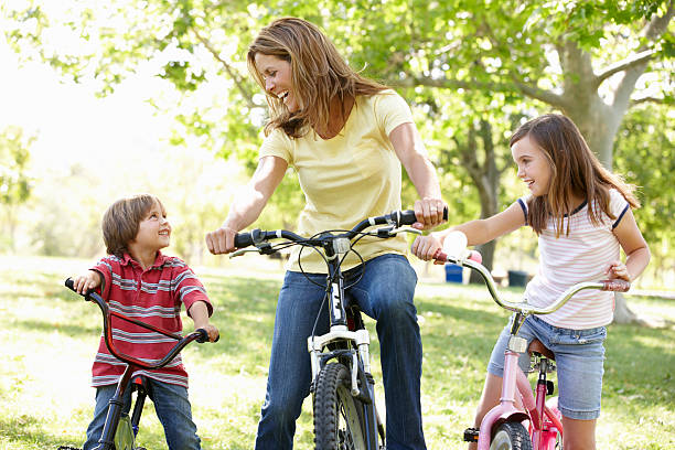 istock Mother and children riding on bikes 155152519