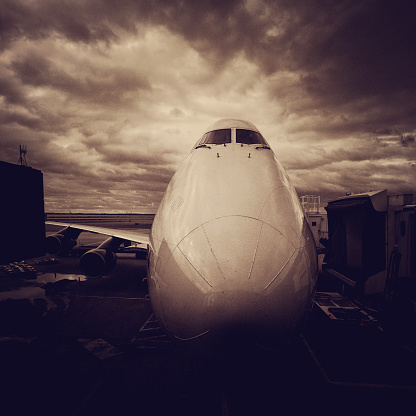 jumbo 747 at the gates in JFK New York airport - menacing sky