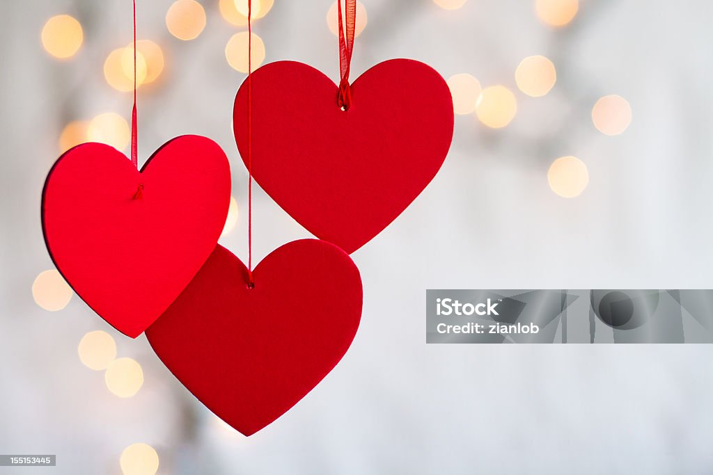 Trois rouge coeur suspendu sur fond flou léger. - Photo de Saint Valentin libre de droits