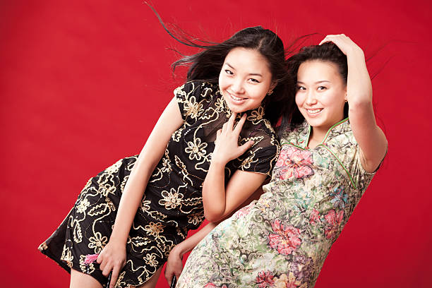 Two cheerful girl-friends. Red background