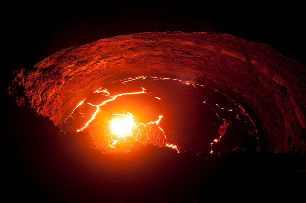 View into the liquid lava lake of Erta Ale volcano View from the crater rim of Erta Ale - one of the most active vulancoes in the world - into the active, red glowing lava lake. danakil desert photos stock pictures, royalty-free photos & images