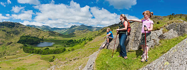 istock Family hiking looking over idyllic mountain valley 155153741