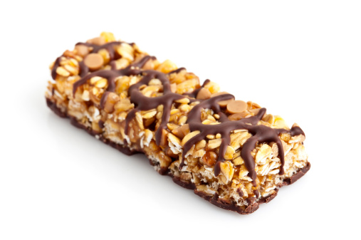 Chocolate and peanut butter energy bar close up on white background