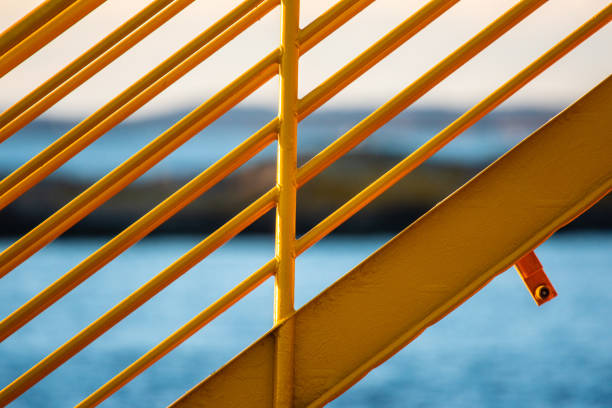 Yellow metal hand railings on a ferry.