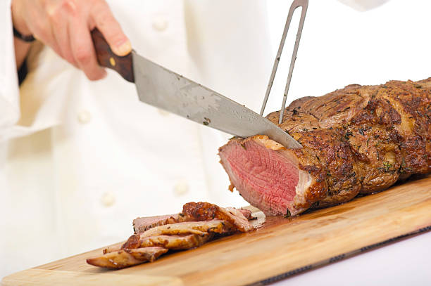 istock Chef cutting slices from a piece of roast beef 155154007
