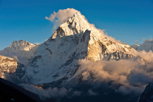 istock Mountain sunset golden light snowy peaks ridges 155154495