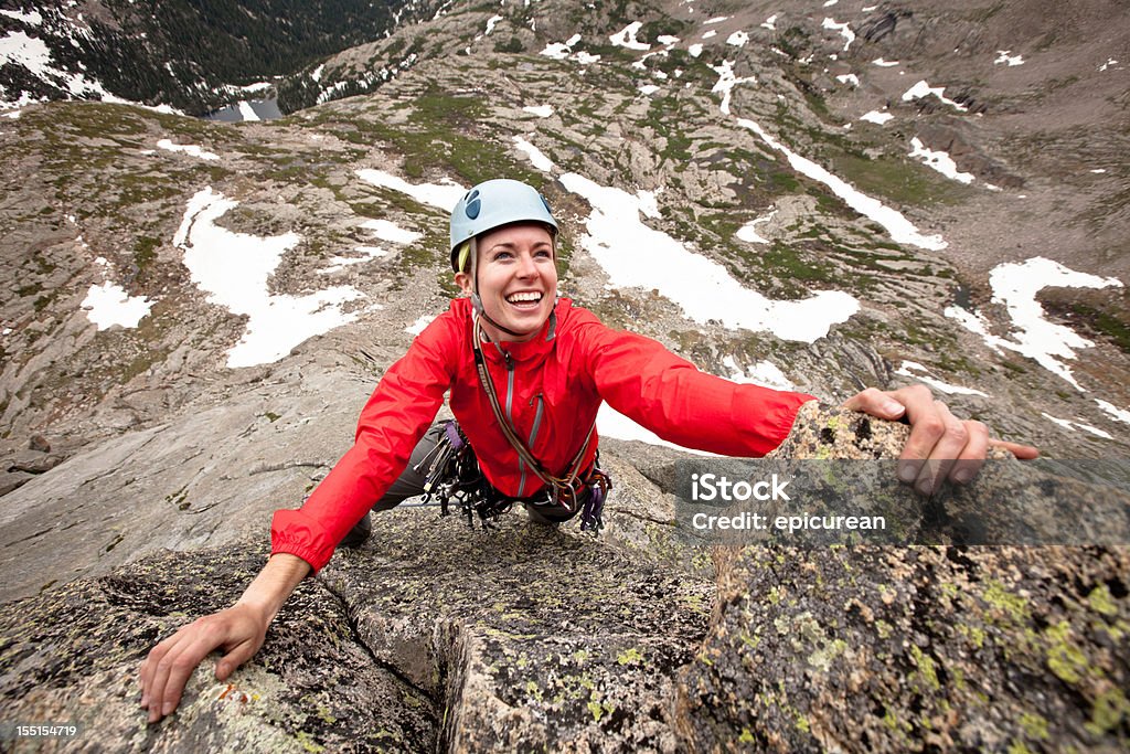 Happy young woman leading a climbing route in Colorado Smiling young woman leading a climbing route in Colorado Spear Head (North Ridge) in Rocky Mountain National Park, Colorado. Women Stock Photo