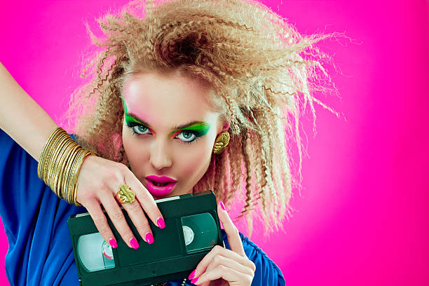 istock 80s beautiful woman with video tape 155154779