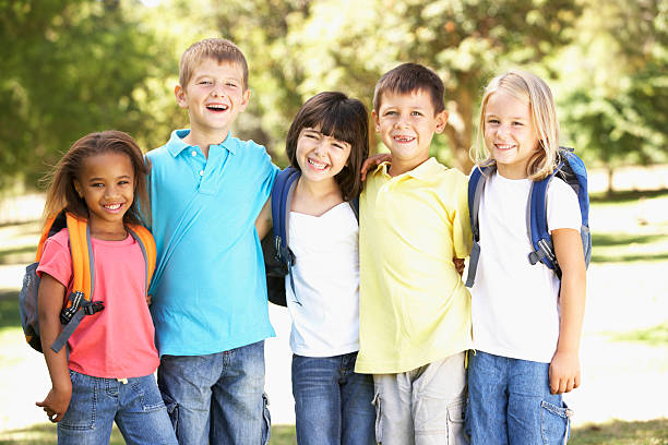 istock Group Of Primary School Pupils Wearing Backpacks In Park 155156456