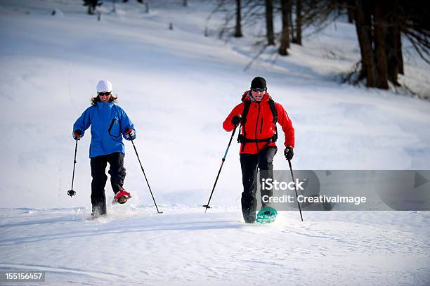 Uomo E Donna Con Le Racchette Da Neve - Fotografie stock e altre immagini di Abbigliamento da sci - Abbigliamento da sci, Adulto, Alpi