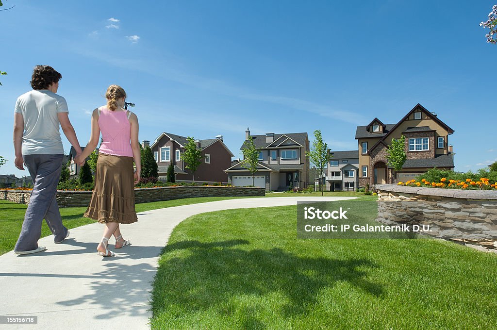 Young couple walking to their new suburban house.  Couple - Relationship Stock Photo