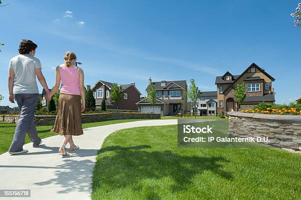 Young Couple Walking To Their New Suburban House Stock Photo - Download Image Now - Couple - Relationship, Mansion, Modern