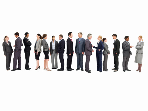 Large group of businesspeople talking with one another while standing in line. Isolated on white. Horizontal shot.