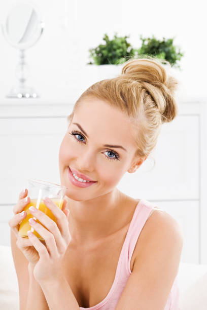 istock Young woman with orange juice 155156988