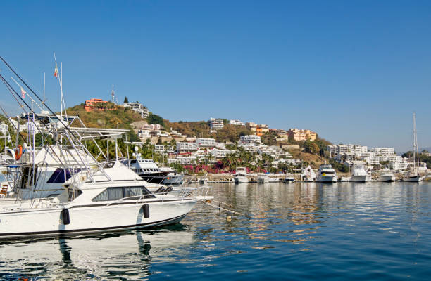 Luxurious villas close to a marina with fishing boats at the Pacific coast near Manzanillo, Colima, Mexico.