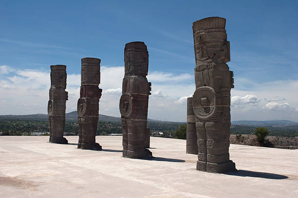 Rear view of the ruins of an ancient mesoamerican city from the Toltec empire in Tula, Mexico. The remaining columns of the temple are sculptures of warriors sometimes referred to as the Atlantians.
