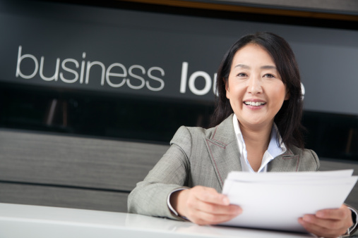 Happy Japanese businesswoman working in business lounge. Istockalypse Tokyo, Japan.