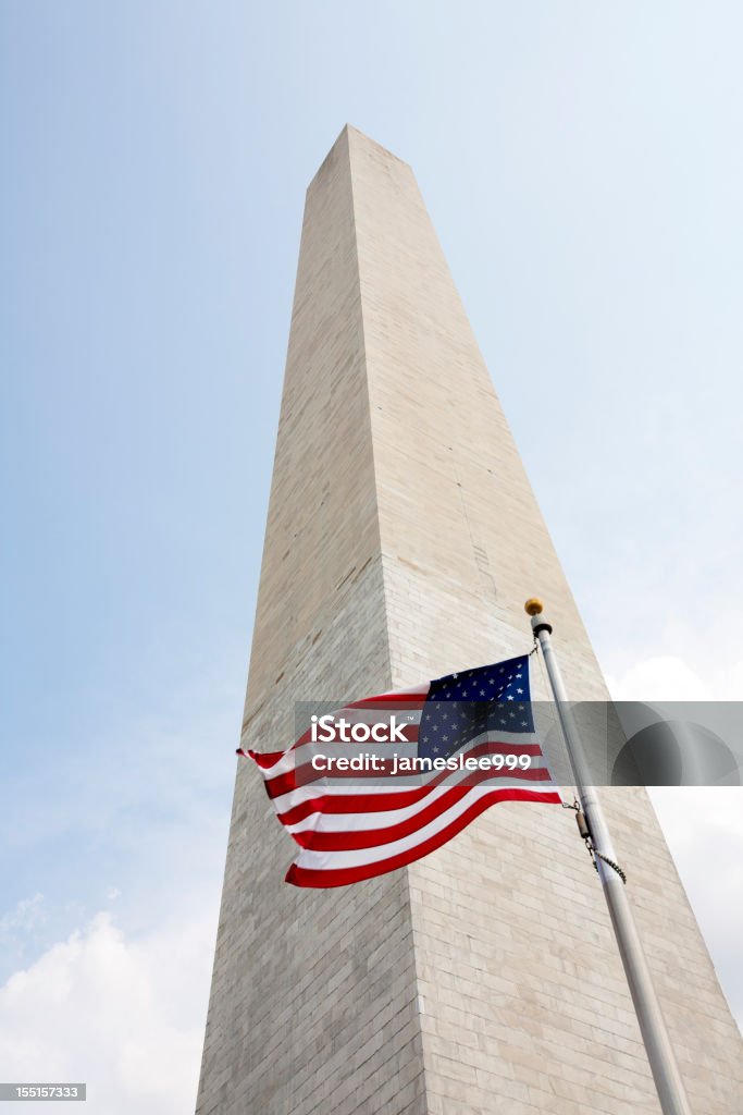 A Washington monument with the American flag Washington Monument and US flag,Washington DC,USA. American Flag Stock Photo