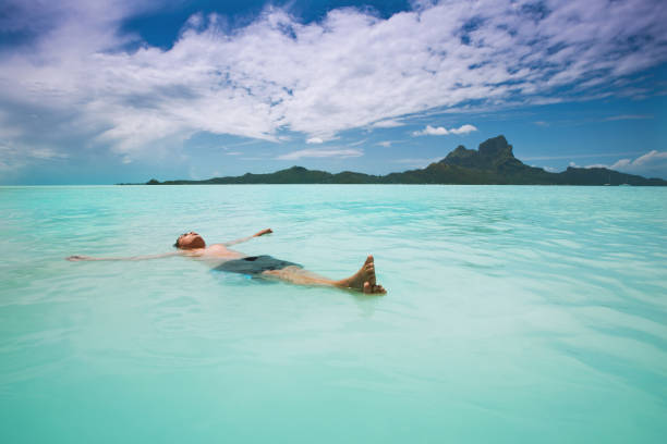 istock Boy relaxing in south pacific Bora-Bora island lagoon 155157400