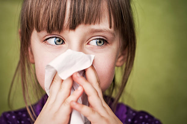 Cleaning nose Little sick girl cleaning her nose  human nose stock pictures, royalty-free photos & images