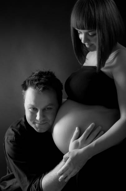 istock Happy affectionate husband hugging his pregnant wife with belly 155157632
