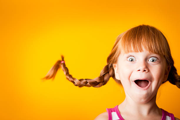 Gasping Red-Haired Girl with Upward Braids and Excited Look Whimsical, color photo of a gasping red-haired girl with upward braids and a look of surprise and excitement! gasping stock pictures, royalty-free photos & images
