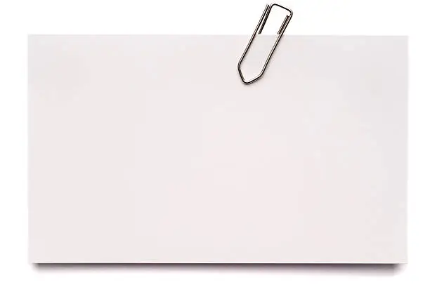 A blank index card with a paper clip, isolated on white.