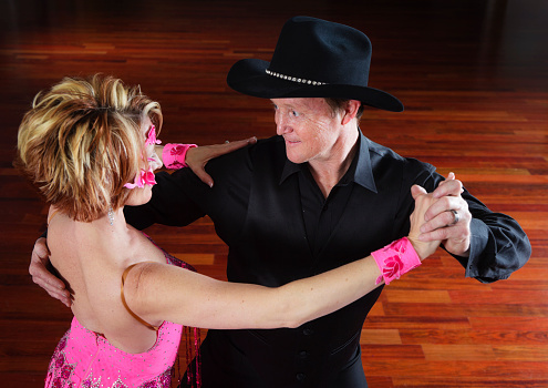 A couple in a ballroom dancing pose.
