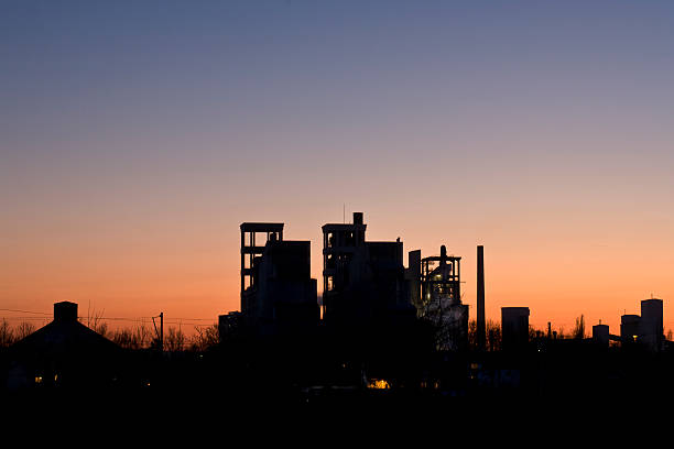 Block of flats in the early morning light. The sun rises behind the building.