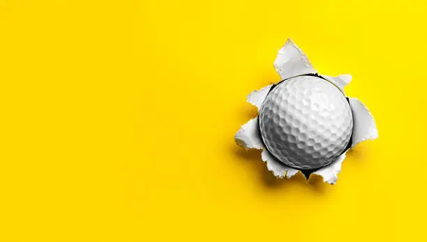 Photo of Golf Ball stuck in Yellow Paper