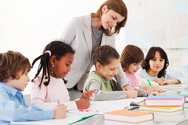 istock School children in classroom with a teacher. 155158302