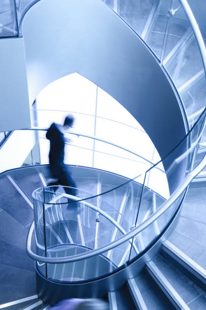 istock Man in Motion on Spiral Staircase 155158449