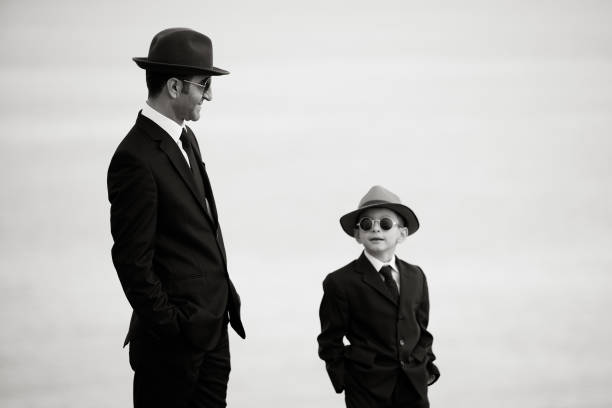 Father And Son Posing In similar Clothes