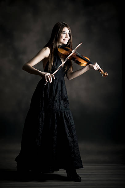 istock Young woman playing violin 155158723