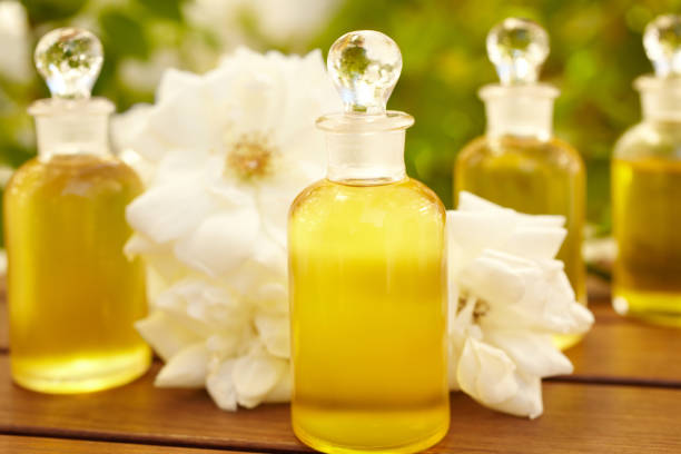 Massage oil bottles at spa outdoors with roses