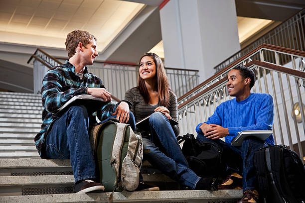 istock Multiracial students  on steps of school building 155159105
