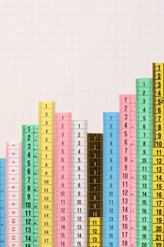 Multicolored sections of tape measures forming bar graph