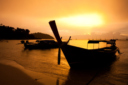 Sunset Beach Koh Lipe Thailand with a silhouette of a Longtail Boat