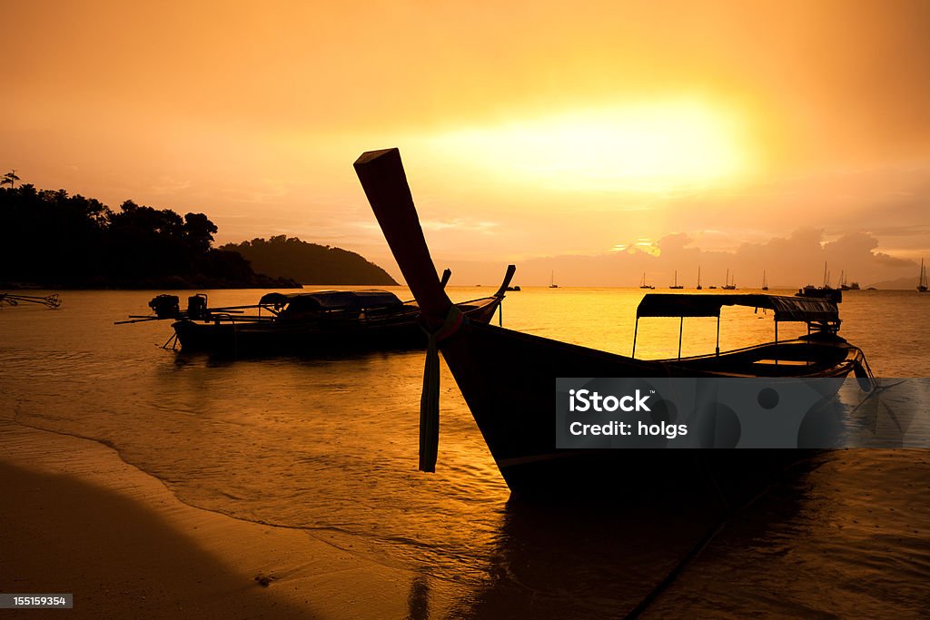 Sunset Beach Koh Lipe Thailand Sunset Beach Koh Lipe Thailand with a silhouette of a Longtail Boat Asia Stock Photo