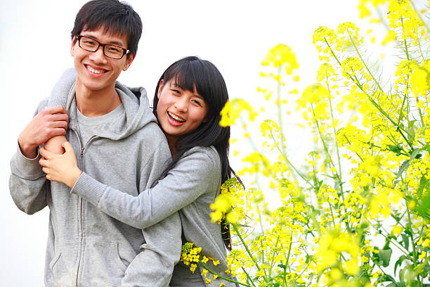 istock happy young couple in the spring field 155159520