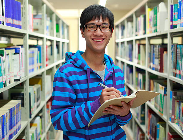istock happy asian college student in the library 155159599