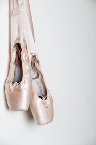 Pointe shoes on a black background top view