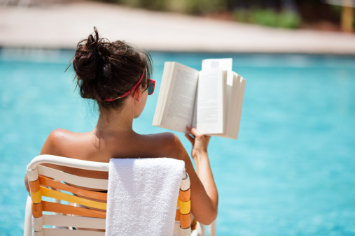 Female reading at the pool