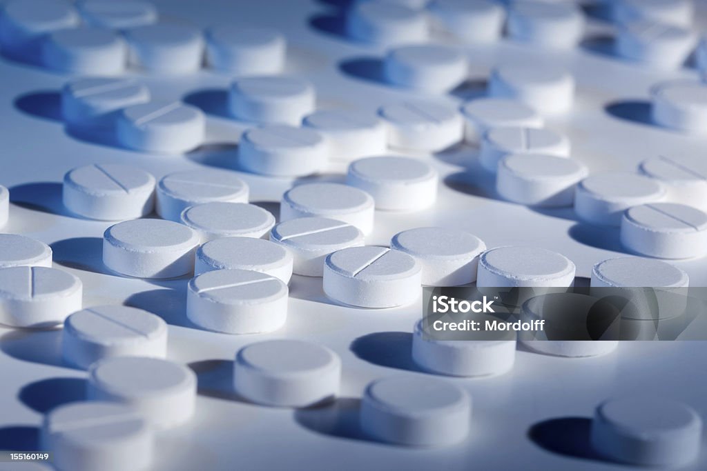 Tablets on white background White pills on white background. Shallow DOF Acetylsalicylic Acid Stock Photo