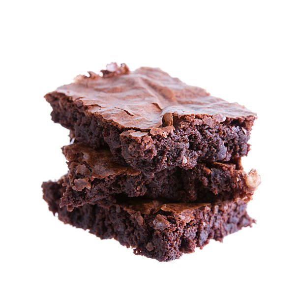 Three brownies on top of each other isolated in white Stock photo of a stack of three homemade chocolate fudge brownies. fudge stock pictures, royalty-free photos & images