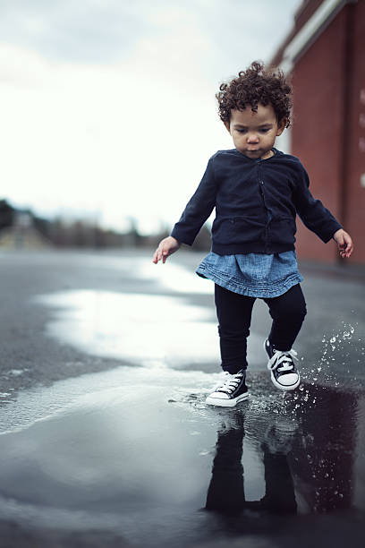 mixed toddler on at a school playground in the fall
